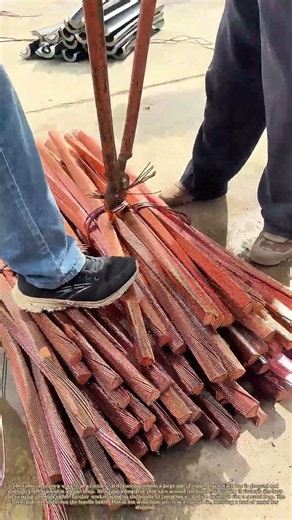 Bundling the Copper: How a Worker Ties a Stack of Bars for Transport