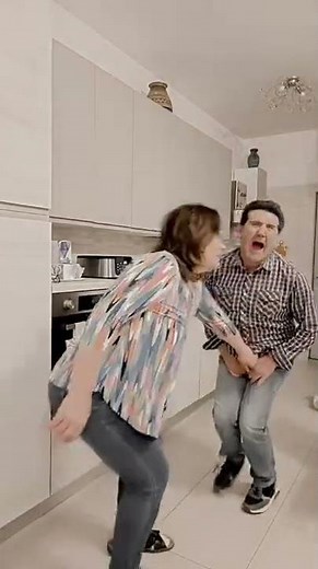 Lady squeezes the balls of the man...