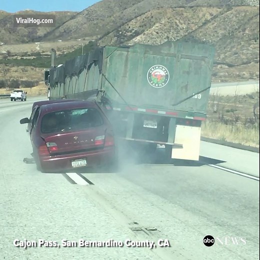 Dramatic video shows tractor-trailer dragging car 4 miles down California's Cajon Pass after the sedan became wedged under the truck. abcnews.com | ABC News