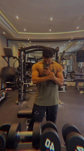 Muscle Flexing in Modern Gym: Fitness Enthusiast Showcase