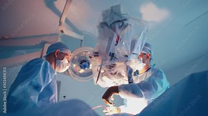 Professional doctors making operation. Two surgeons performing surgery using medical instruments. Modern microscope for surgery.