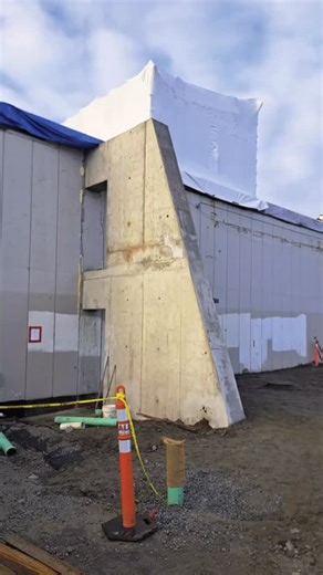 Public Architecture on Instagram: "Yes, it’s a flying buttress. While usually associated with 12th-century cathedrals, this structure at the Grenfell Elementary School Upgrade is a modern case study in efficiency. It doesn’t “fly” just for show. By minimizing the mass in contact with the building, we significantly reduced thermal bridging and heat loss. It represents the exact volume of concrete required for structural safety—meeting rigorous sustainability goals without an ounce of waste. 🎨 Co