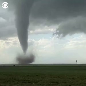As powerful storms sweep across the southern U.S., video captured a tornado blowing across a field in Vernon, Texas on Friday. | CBS News