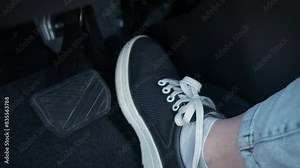 Female foot control the pedals. A view of lady foot on the car pedal during driving time.