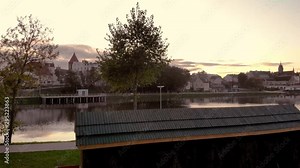 Small graduation tower near pond, a place for recreation and treatment with benches and graduation towers, a spa with walking paths in the middle of a small village by the water,