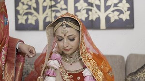Lovely Indian Bride On Her Traditional Dress And Red Veil On A Hindu Wedding Ceremony. Close-up Shot