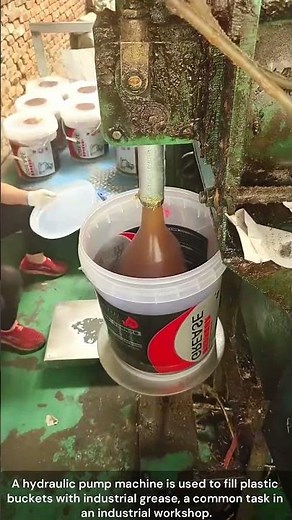 The process of filling a bucket with grease