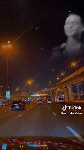 Nighttime Highway Scene with Illuminated Vehicles