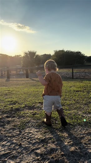 Adorable Boy in Cowboy Boots Stomps Around the Barn