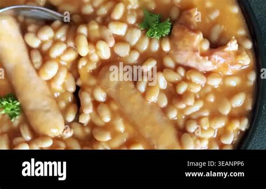 Beans tomato sauce with meat and sausages Cassoulet french cuisine tasty snack fresh gourmet food background on the table rustic food top view copy space Stock Video Footage - Alamy