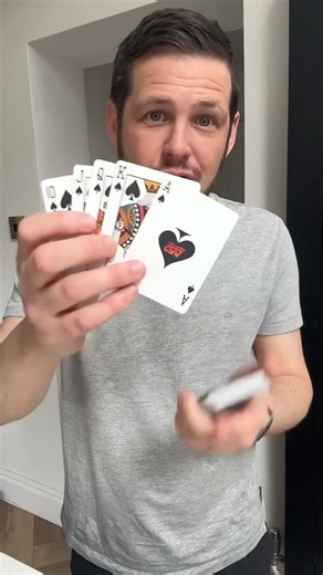 Magician demonstrates an unusual card illusion