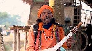 Indian folk artist sings melodious songs in the heart of nature, harmonising with the serene surroundings, a soulful connection to tradition.