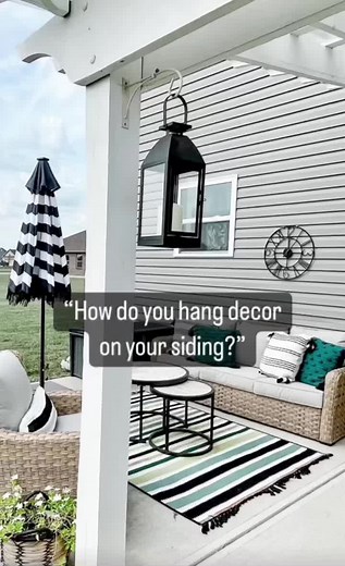 The handy siding hooks are perfect for hanging outdoor decor minus the holes! #patiodecor #outdoordecor