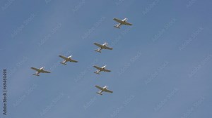 Small airplanes performing aerobatic flight at the airshow.