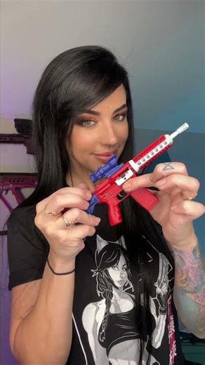 Our girl Alex showing off her GoatGuns mini AR vs the real thing!