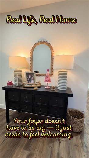 The foyer is the first hello of your home. It doesn’t have to be fancy — just thoughtful. A little light, a mirror to reflect it, and pieces that tell your story can make anyone feel welcome the moment they walk through the door. First impressions start right here. #FoyerDecor #EntrywayStyle #RealLifeRealHome #HomeWithHeart #SimpleDecor