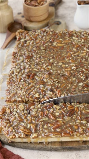 These Pecan Pie Cheesecake Bars are one of those desserts that feel extra special the moment you cut into them. They start with a buttery pecan graham cracker crust, topped with a rich, creamy cheesecake layer, and finished with a gooey pecan pie topping that ties everything together perfectly. 🤎 Check out this amazing recipe here: https://www.piesandtacos.com/pecan-pie-cheesecake-bars/ | Pies and Tacos