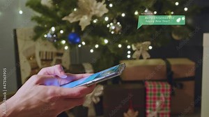 Woman chatting in handy smartphone and texting messages in phone with virtual pop up dialog. Writing congrats for friends online. New year time, christmas holidays