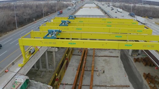 Willow Springs, IL - Drive along the I-294 Illinois Tollway and you can't miss the bright yellow gantry moving and installing bridge beams for the Mile Long Bridge. #WalshAtWork #Ironworkers | The Walsh Group