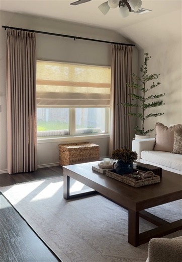 swapped out our builder grade blinds for these custom pleated fold roman shades from @Cozyology and they completely changed the feel of the space! I chose the Lena Linen fabric in Moonlight Beige with no liner for a soft, filtered light look, and they're motorized so opening and closing them is as easy as pressing a button. If you've been thinking about updating your windows, this is your sign 🤍 #romanshades #windowtreatment #buildergradeupgrade #homedecor #cozyhome creating a cozy home builder