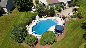 For this #flyoverfriday we have a special one! This custom TrueStone liner is a mix and match of three different patterns. The features and steps are Pearlstone, the walls are Gray Crystal, and the floor is Blue Slate. All three come together as a beautiful combo that coordinates great with each other and the masonry as well! #glipoolproducts | GLI Pool Products