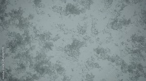 Wet snow falls on the glass melts and flows a drop down on a window at Christmas time. Cold wet weather on window pane.