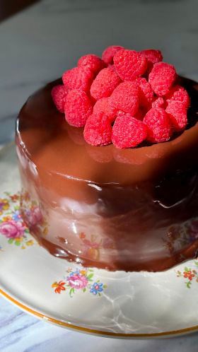 Chocolate Mirror Glaze Cake with Raspberry Coulis