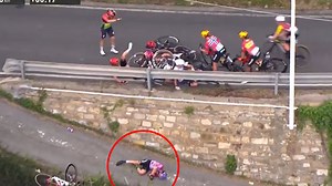 Cyclist plunges off huge drop in horror race crash as rivals collide in pile-up
