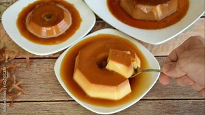 Close up of man hand taking a slice of condensed milk pudding. Traditional Brazilian sweet. Zoom in and slow motion. Stock Video