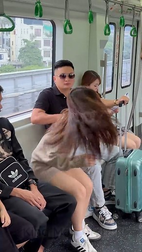 On the crowded train, she was being controlled—unable to scream, unable to escape. All she had left… was her hand. She formed the Silent SOS. KindMan saw it instantly and answered with a calm, steady gaze: *“I’m here.”* He walked closer, pretended to trip, and kicked the man’s suitcase away. The man instinctively let go to catch it— giving the girl the one second she needed to run. When he turned back to chase her, KindMan stepped in and blocked his way. Because sometimes, one silent signal and 