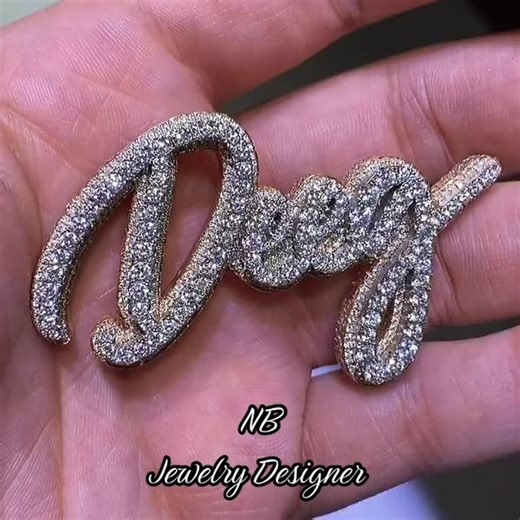 ✨ Custom Iced Name Pendant ✨ Dripping in diamonds and fully flooded with stones 💎 This custom script name pendant is handcrafted in solid gold and covered in high-quality pavé-set stones for that ultimate shine from every angle ✨#CustomJewelry. #IcedOut #NamePendant #DiamondPendant #JewelryDesign LuxuryStyle BlingBling | NB jewelry Designer