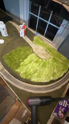 Watch as I add static grass to my model train layout. Stick around to the end to see the results.