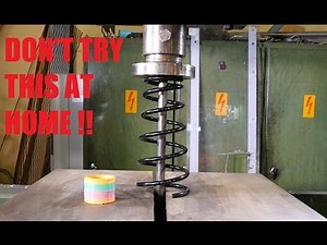 Crushing car spring with hydraulic press