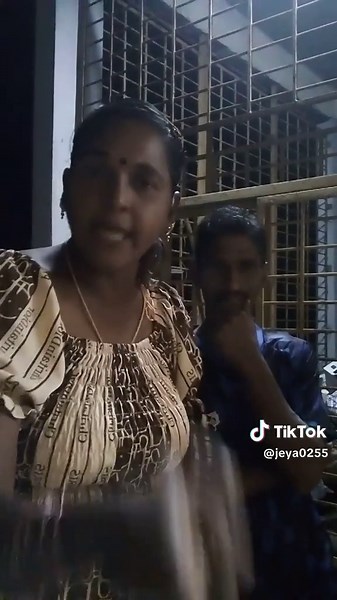 Hand Gestures in Patterned Dress and Blue Shirt