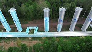 The plant produces H2 hydrogen and fills the storage tanks with it. Hydrogen moves through the pipes. ESG clean energy concept.