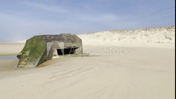 German World War II bunker stranded on the beach of Cap Ferret in southwest France after coastal erosion, originally built on top of the dune decades ago, Atlantic Wall relic facing ocean