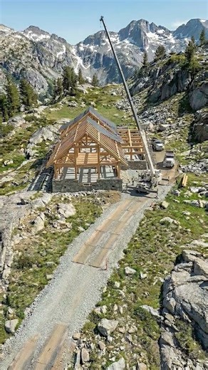 Alpine mountain lodge on a grassy slope #architecture