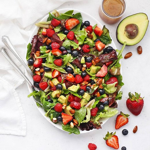 Mixed Berry Green Salad- This Berry Salad is packed with gorgeous berries, nuts, and avocado, tied together with a bright, tangy dressing. It's the perfect yummy side dish or main dish! (Gluten-Free, Vegan-Friendly, Paleo) GET THE FULL RECIPE MORE MIX-IN IDEAS HERE: https://www.onelovelylife.com/mixed-berry-salad/ | One Lovely Life