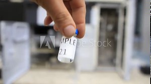 A man holds a vial with a sample of water to perform trace analysis looking for pesticides, organic solvents and heavy metals