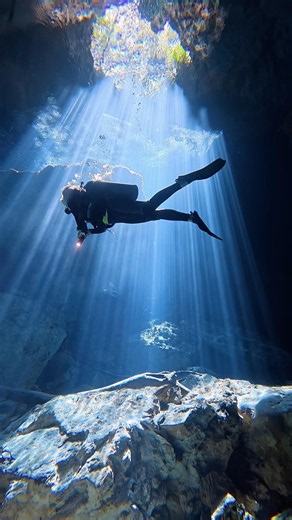 Diving through the sun rays in the Tajma-Ha Cenote in Playa Del Carmen, Mexico. #scubadiving