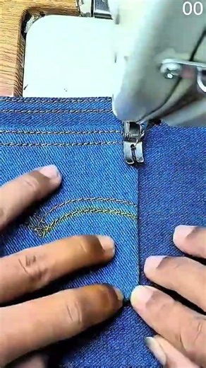 Denim guided under needle for precise seam stitching