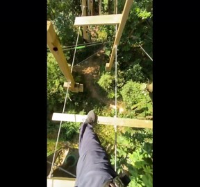 Man crosses rotating steps on high bridge in Foshan, China