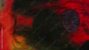 Glitter mist. Ink water bubble. Defocused black red golden blue color particles smoke texture paint drop floating on dark abstract art background.