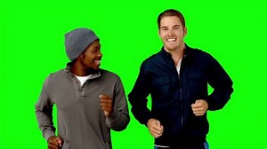 Two men running on green screen in slow motion on green screen