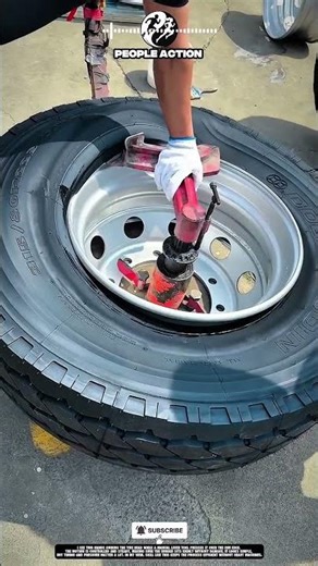 Manual tire mounting on steel rim using simple lever tool 🔧