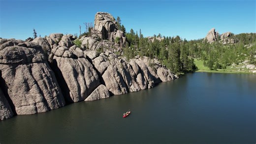 Aerial View of Kayak in Sylvan Lake, Custer State Park, South Dakota USA on Sunny Summer Day | Premium Stock Video Footage
