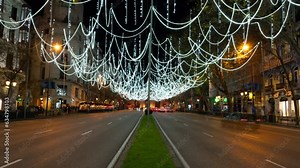 Night timelapse of the Alcala street decorated with Christmas lights. Timelapse at night in Alcala Gate. Close up traffic as foreground and Madrid downtown as background. Traffic Time lapse in Madrid