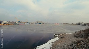 Timelapse of harbor in export and import business. Shipping cargo to pier by crane. Barge is being towed by two tugs. Concept of transport logistics and maritime in winter