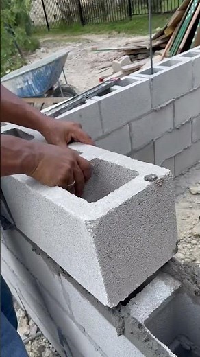 Installing 8x8x16 CMU for retaining wall! #austintexas #concrete #construction #landscape #wall