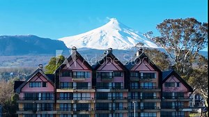 Volcano Behind Building At Pucon In Los Rios Chile. European Buildings. Vulcanic Scenery. Tourism Landscape. Pucon Chile. Volcano Background. Volcano Behind Building At Pucon In Los Rios Chile.